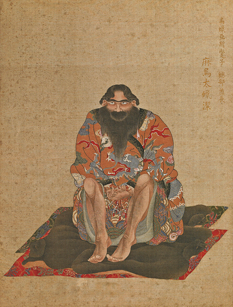 A color painted portrait of an Ainu chieftain sitting on a mat with his knees pulled to his chest. He is bearded and wearing a patterned outfit.