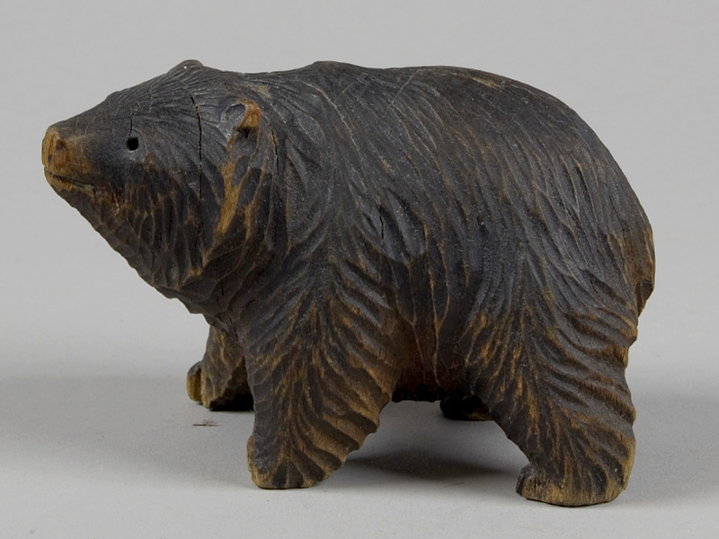 A photograph of a carved wooden bear.