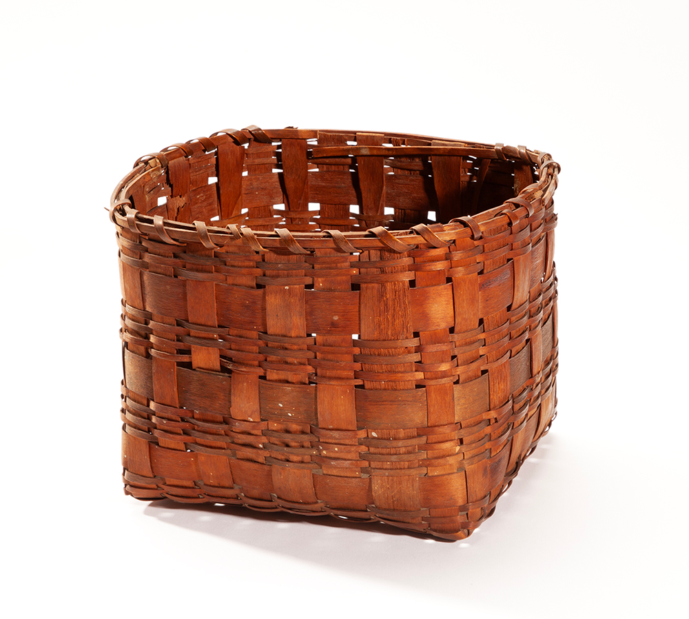 A basket possibly made of cedar with woven patterns.