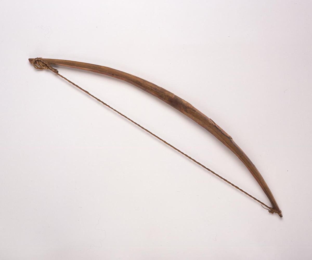 A small wooden arrow with a grass twine string.