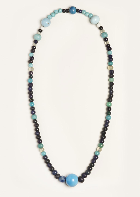 A traditional Ainu necklace made of various class beads in shades of blue and black.