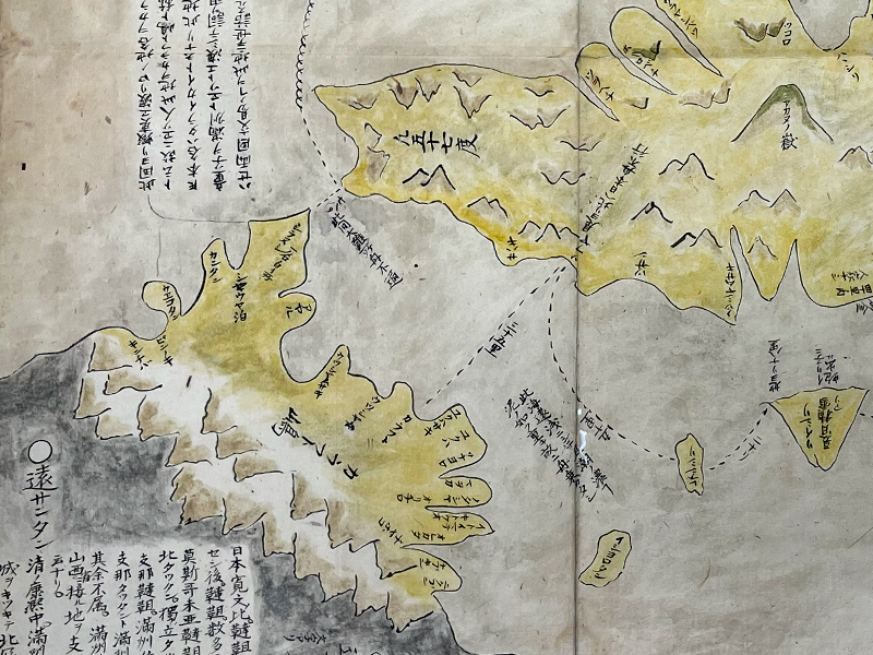 A segment of a handpainted map showing land masses in yellow and gray.