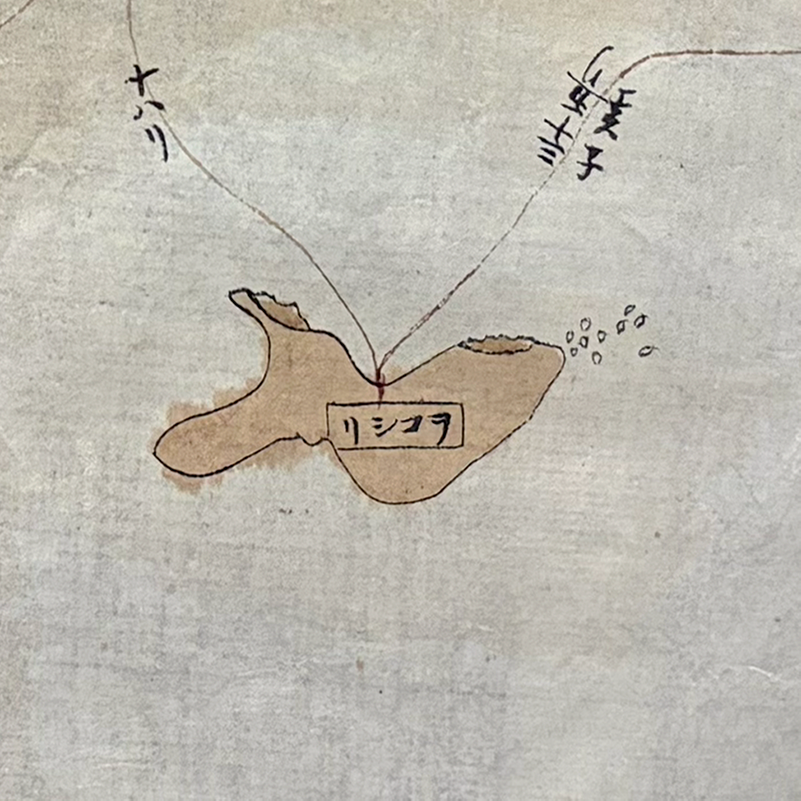 A closeup of an island on the map painted in brown. The Japanese label has the characters written in reverse.