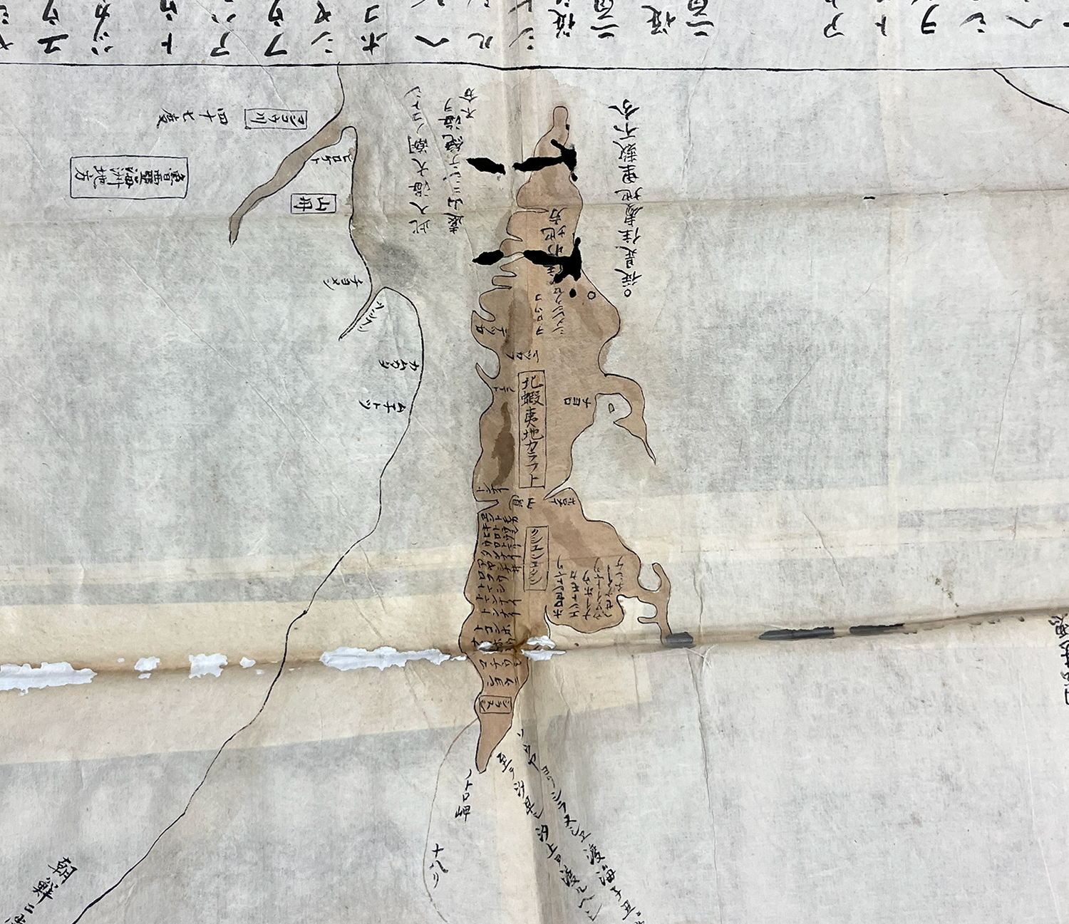A closeup of Sakhalin island, depicted in black lines and brown wash.