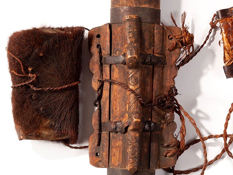 A closeup photograph of an Ainu wooden quiver.