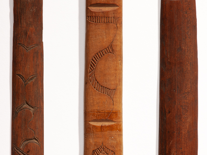 A closeup photograph of an Ainu ikupasuy carvings.