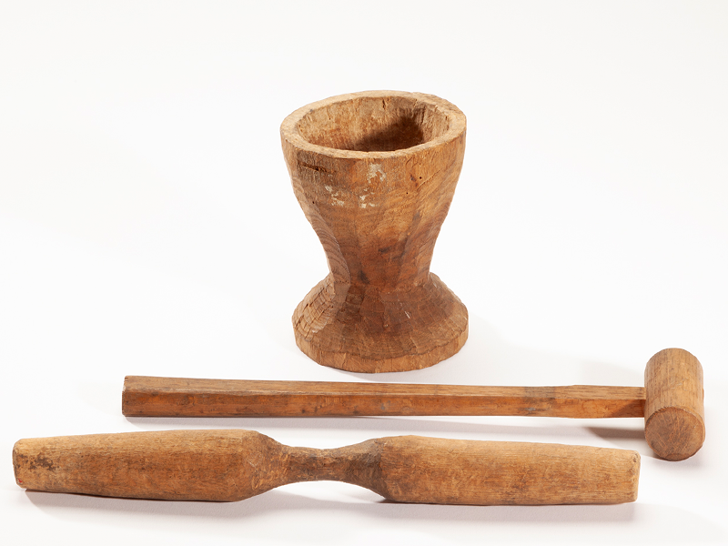 A closeup photograph of an Ainu model mortar pestle and hammer.