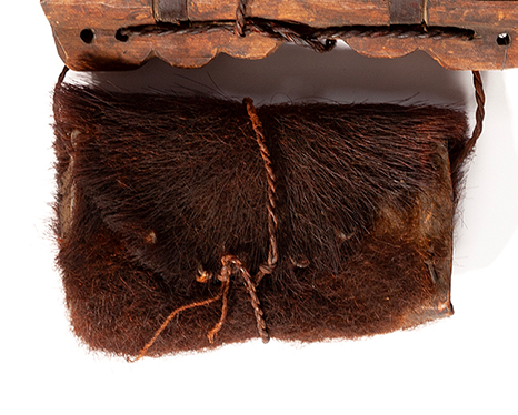 A small pouch made of a brown bearskin and fur.