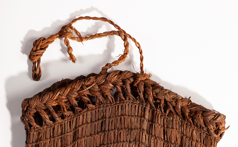 A closeup of a saranip basket's knotted and woven rim.