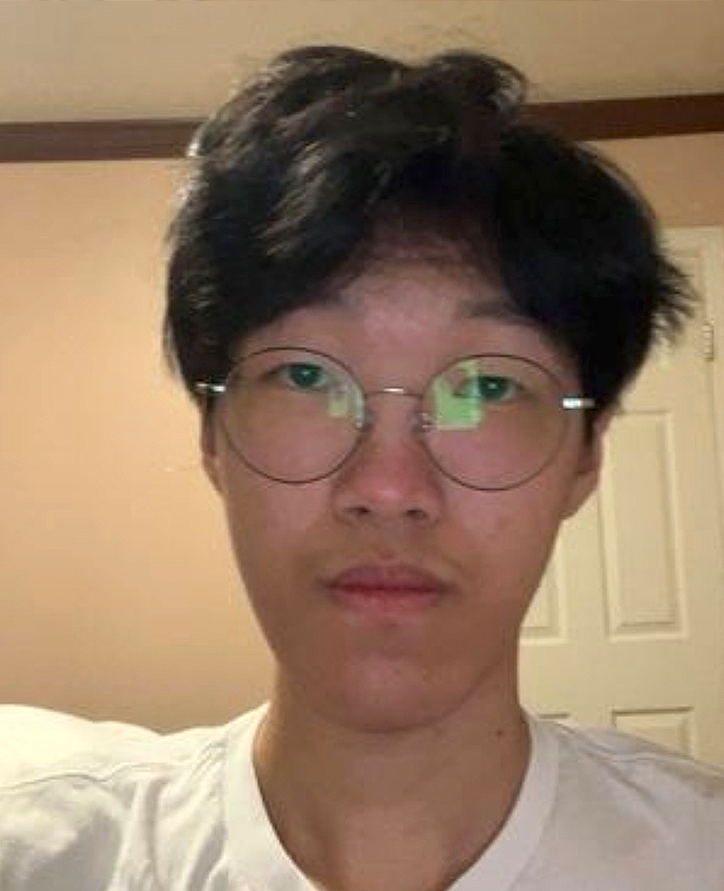 An Asian man wearing glasses with a neutral expression.